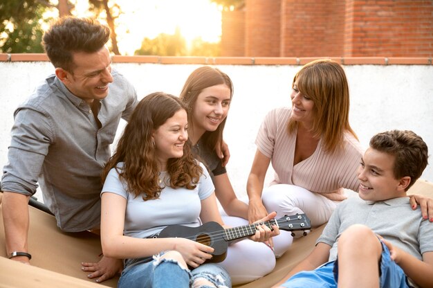 Family gathering and playing the ukulele together