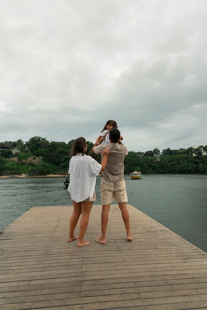 Free photo family hanging out on a jetty