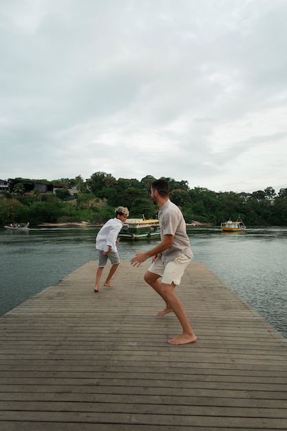 Free photo family hanging out on a jetty