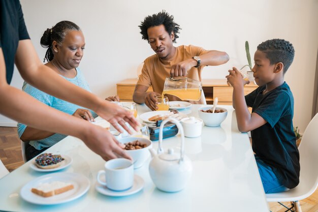 Family having breakfast together at home.