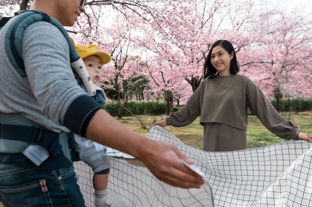 Family having a picnic next to a cherry tree