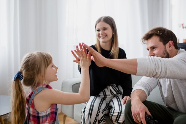 Family high-fiving in living room