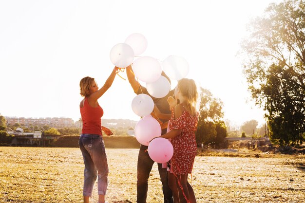 Family holding bunch of balloons