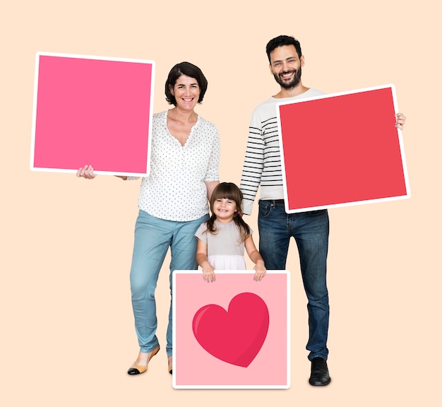 Family holding pink square boards