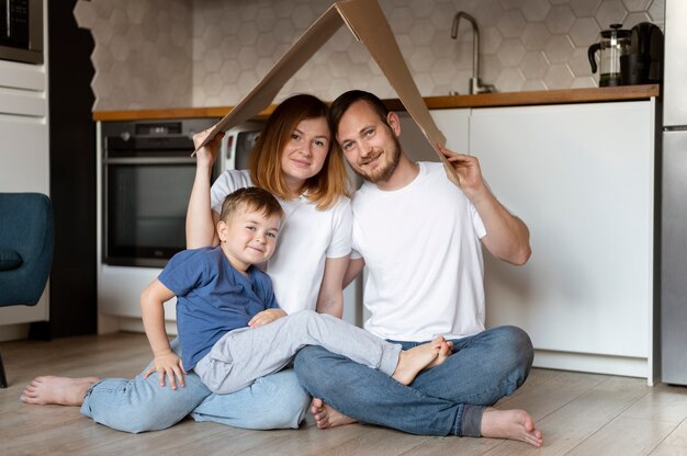 Family holding a roof above their head