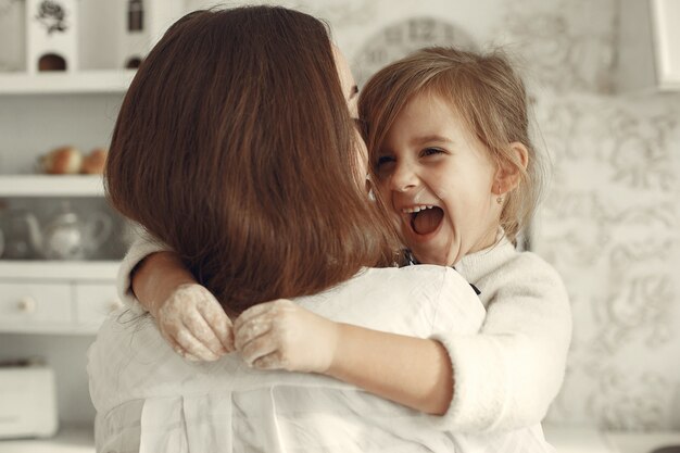 Family at home. Mother with daughter in a room.