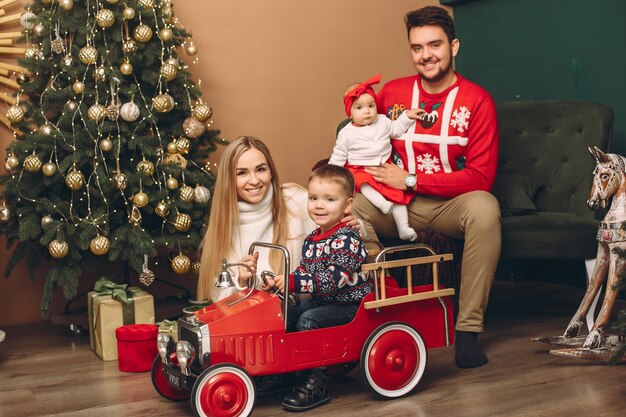 Family at home near christmas tree