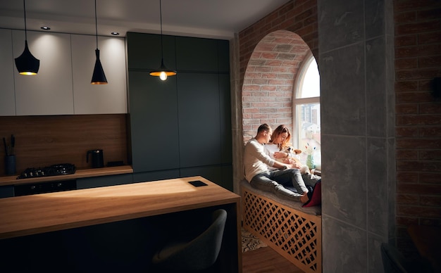 Family is resting on windowsill bed