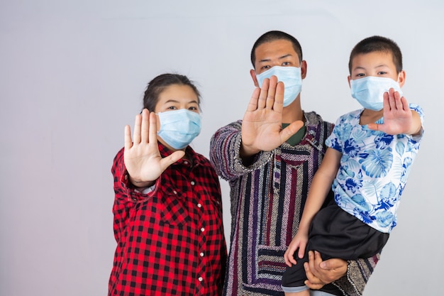 Free photo the family is wearing a medical protective mask