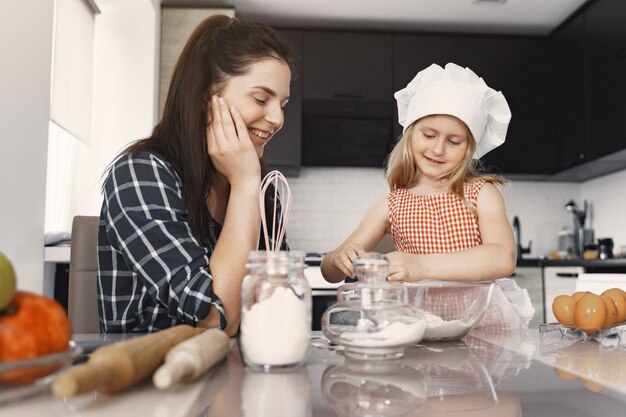 Family in a kitchen cook the dough for cookies