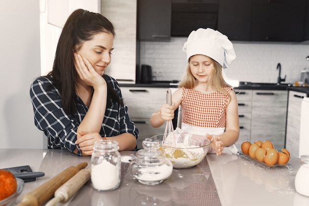 Family in a kitchen cook the dough for cookies