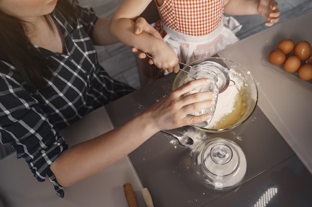 Family in a kitchen cook the dough for cookies