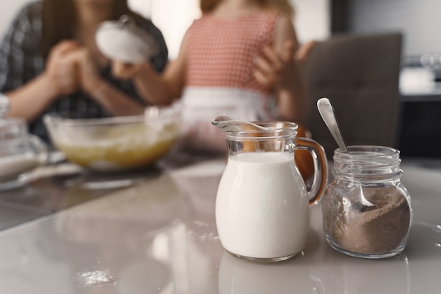 Family in a kitchen cook the dough for cookies