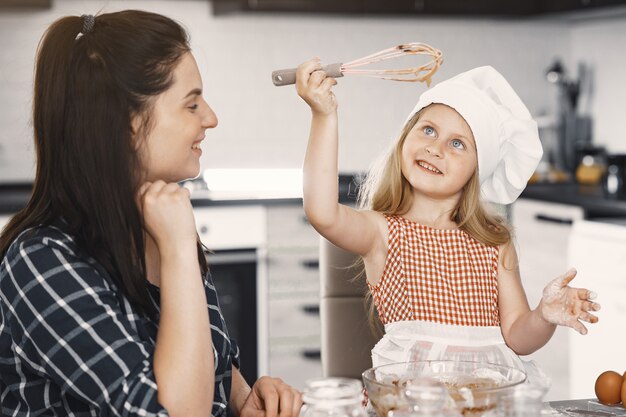 Family in a kitchen cook the dough for cookies