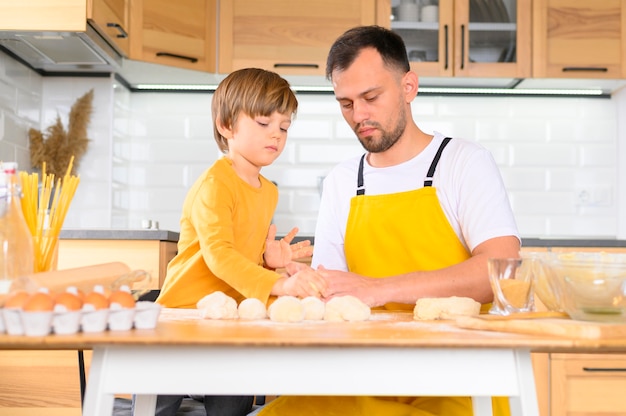 Family knead the dough with bare hands front view