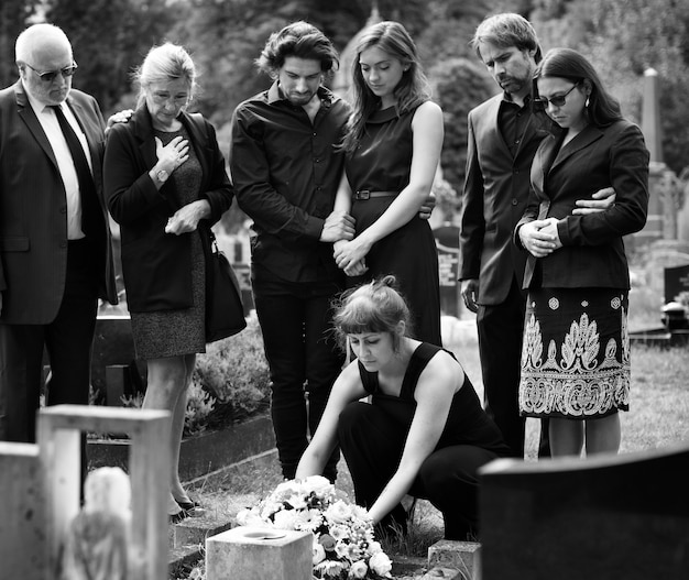 Family laying flowers on the grave