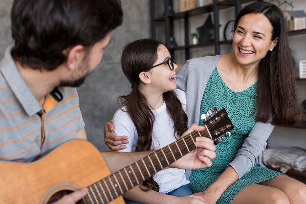 Family learning to play instrument