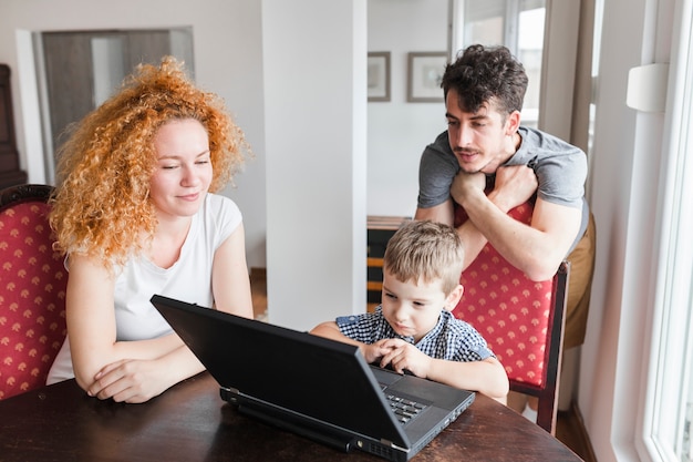 Family looking at laptop