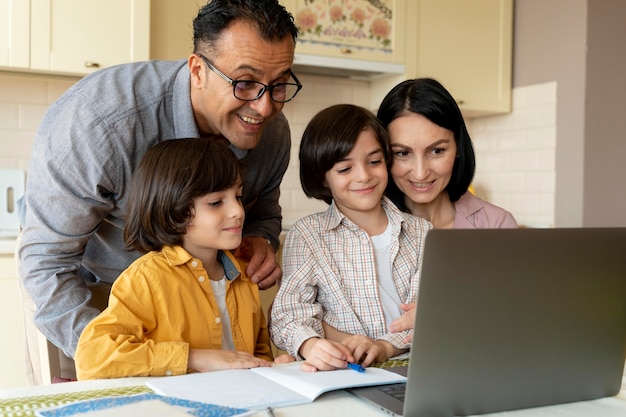 Family looking together on a laptop at home