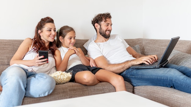 Family looking together at laptop