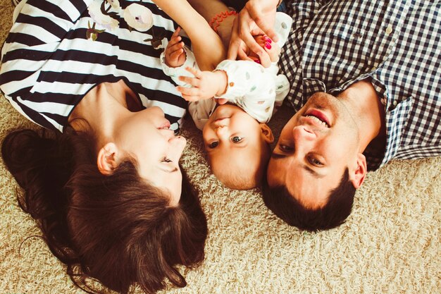 Family lying  on the carpet