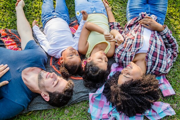 Family lying together on the ground