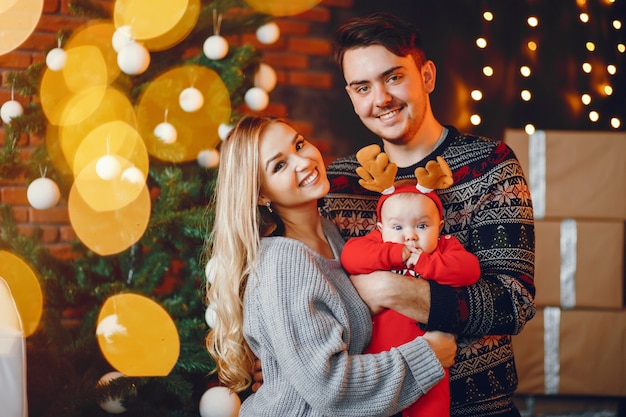 Free photo family near christmas tree