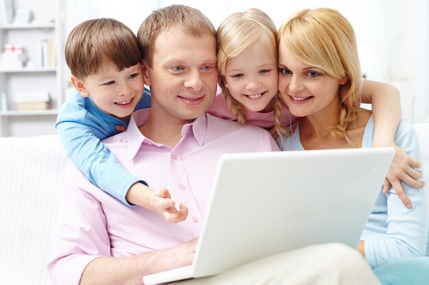 Family paying attention to laptop