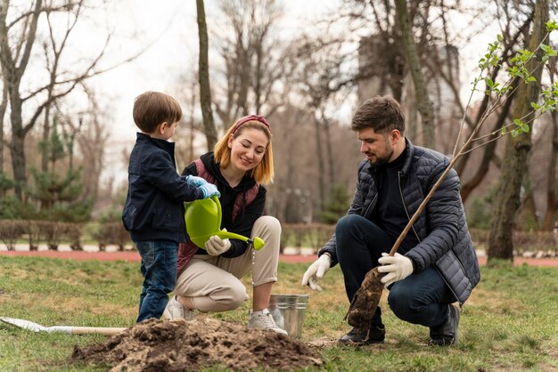 Family planting together outdoors