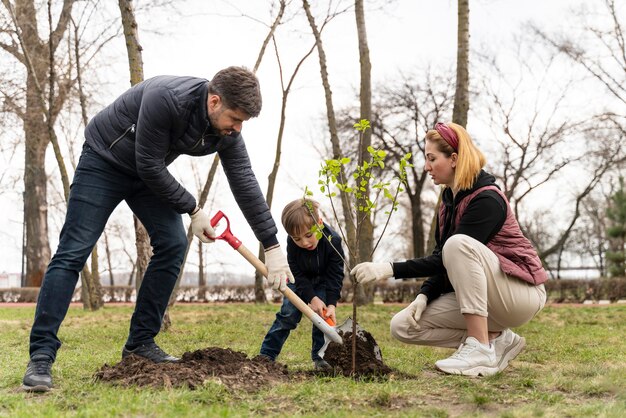 Family plating together a tree