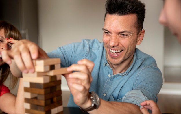 Family playing stacking game together at home