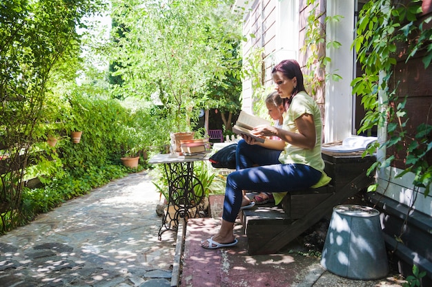 Free photo family on porch reading book