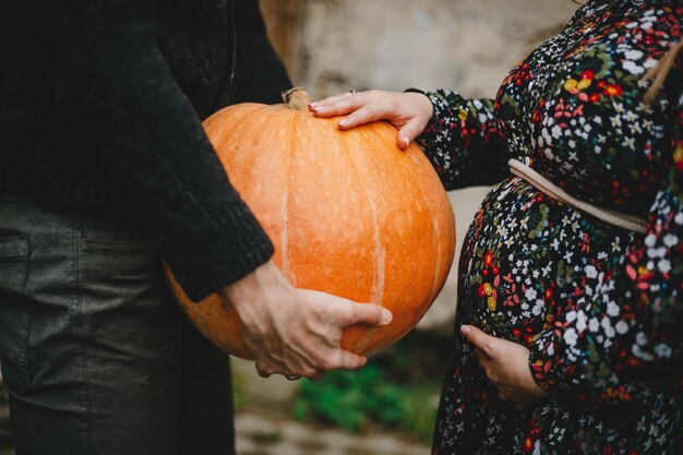 Family portrait. Charming pregnant couple poses outside 