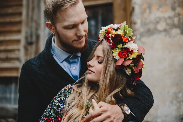 Family portrait, expecting couple. Man hugs tender pregnant woman