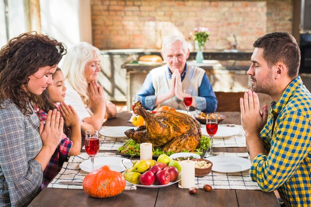 Family praying before meals