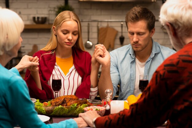 Family praying at the dinner table