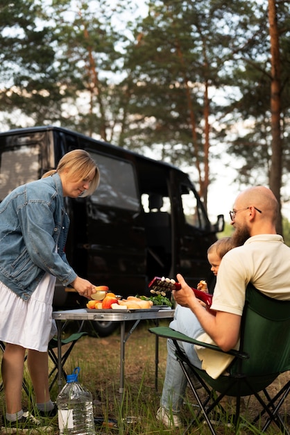 Family preparing dinner while in camping