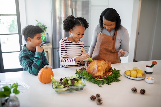 Family preparing the thanksgiving day turkey