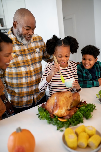 family preparing the thanksgiving day turkey
