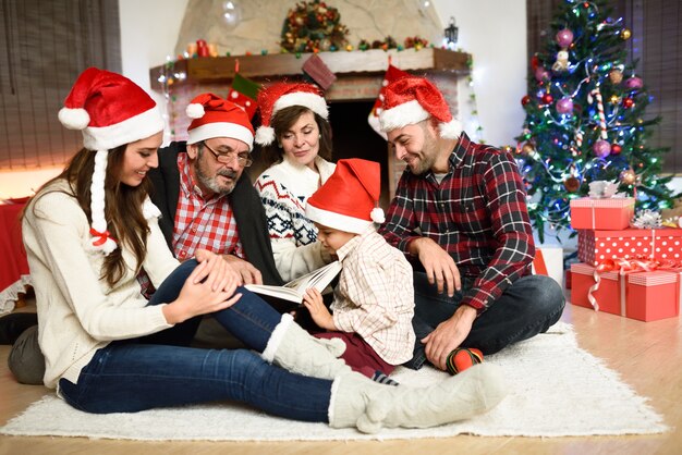 Family reading a book together in their living room