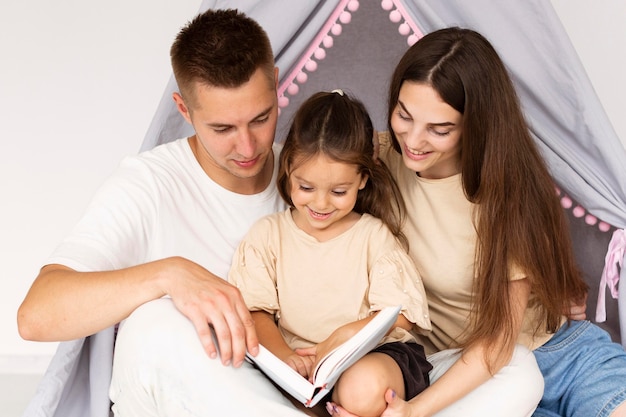 Family reading together from a book