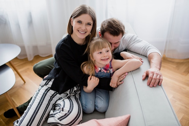 Free photo family resting on sofa