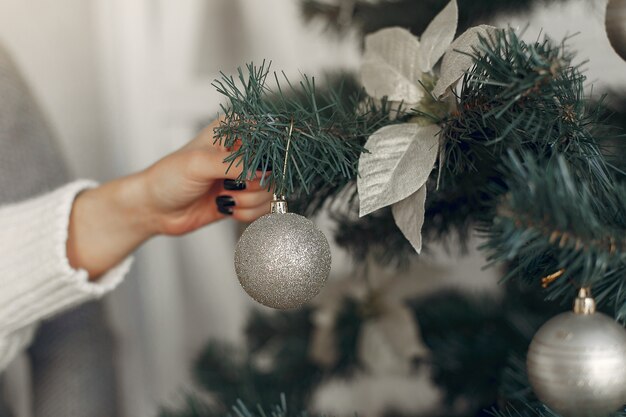 Family in a room. Little boy near christmas decoration. Mother with father with son