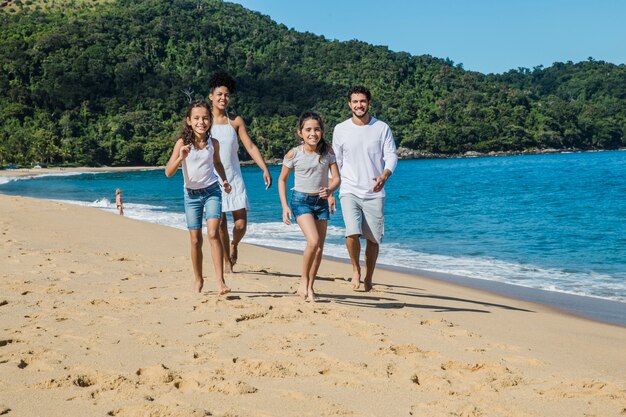 Family running on the beach