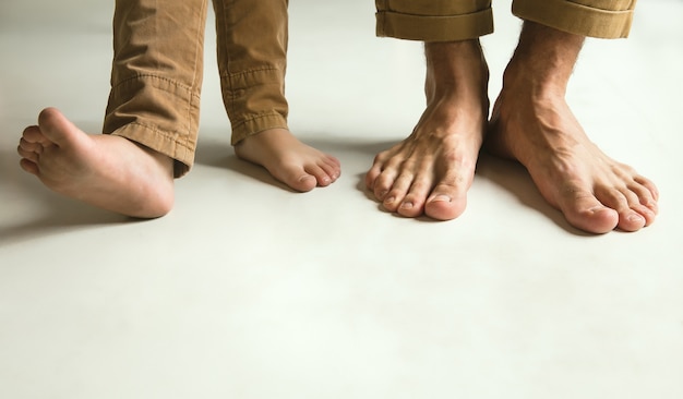 Family's legs on white