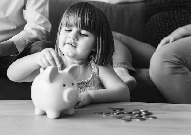 Family saving money in a piggy bank