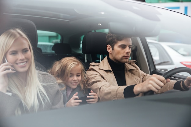 Family sitting in car