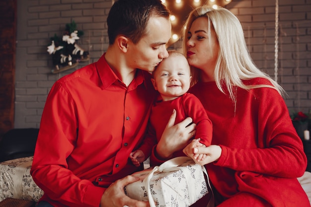 Family sitting at home on a bed