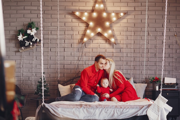 Family sitting at home on a bed