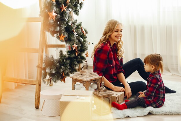 Family sitting at home near christmas tree